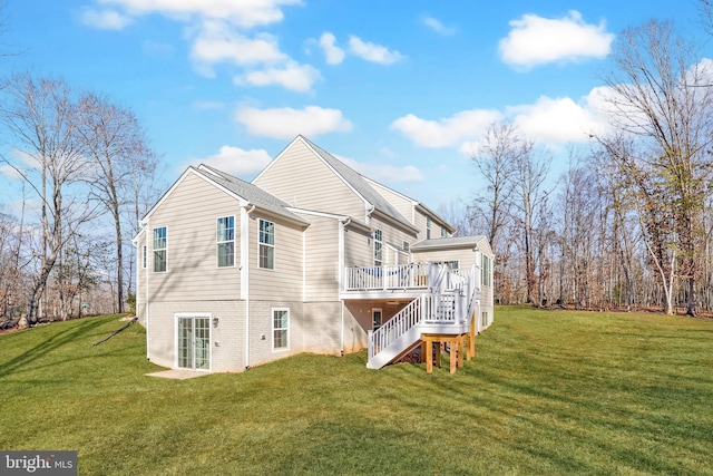 back of property with a deck and a lawn