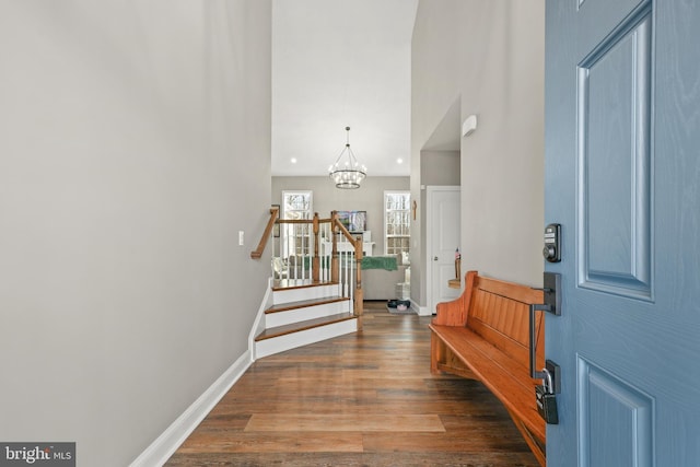 entryway featuring dark hardwood / wood-style floors and a notable chandelier