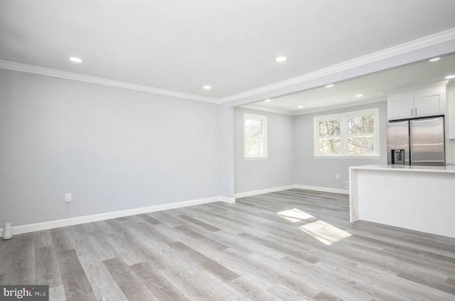 unfurnished living room featuring light hardwood / wood-style floors and ornamental molding