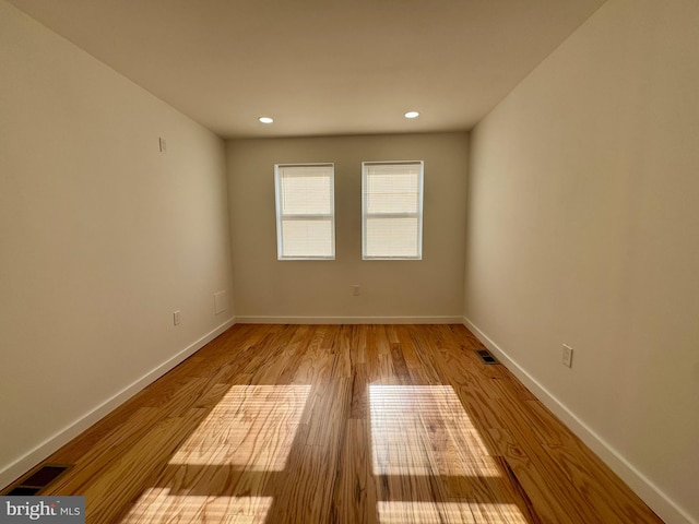 unfurnished room with light hardwood / wood-style floors