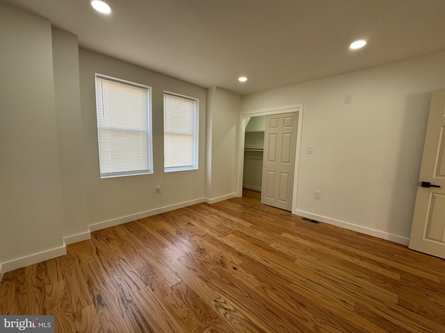 unfurnished bedroom featuring a closet and light wood-type flooring