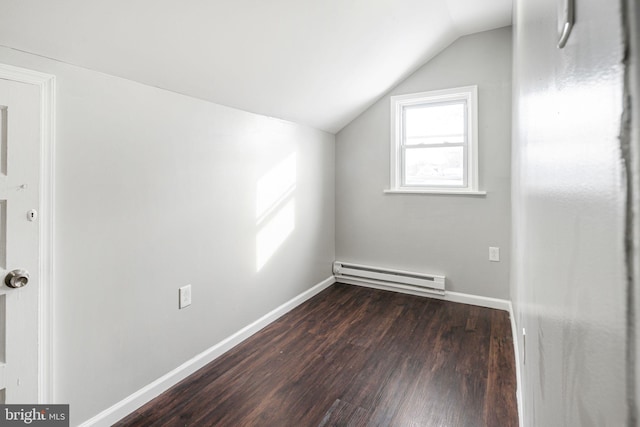 bonus room with a baseboard heating unit, dark hardwood / wood-style floors, and lofted ceiling