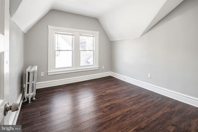 bonus room featuring radiator, dark hardwood / wood-style floors, and lofted ceiling