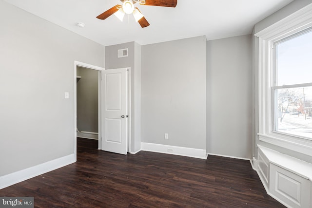 spare room featuring ceiling fan and dark hardwood / wood-style floors