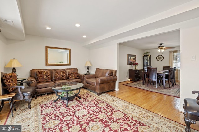 living room with light wood-type flooring and ceiling fan