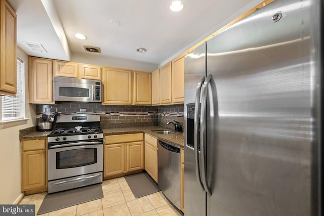 kitchen with sink, light brown cabinets, and stainless steel appliances