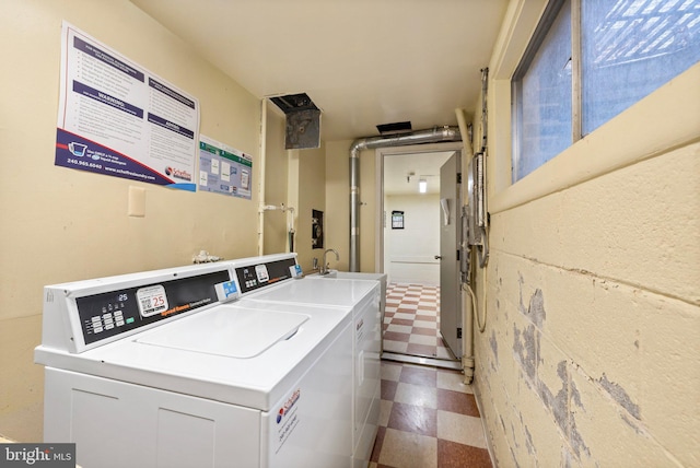 washroom with washing machine and dryer and sink