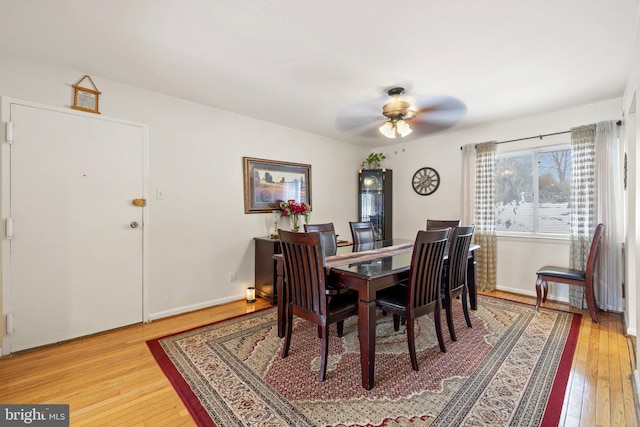 dining area with hardwood / wood-style flooring and ceiling fan