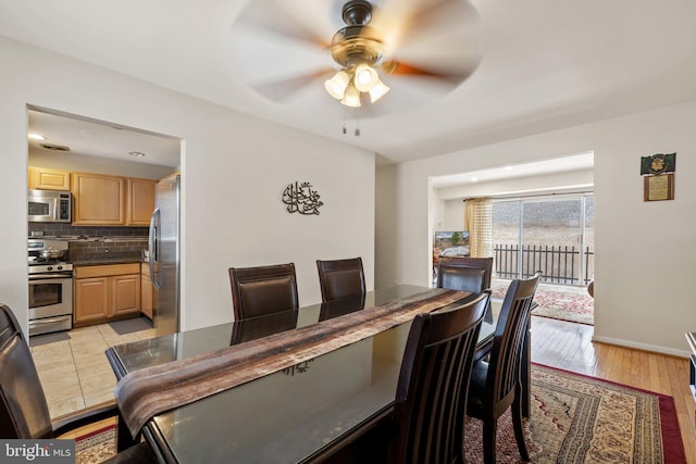 dining area with light hardwood / wood-style floors and ceiling fan