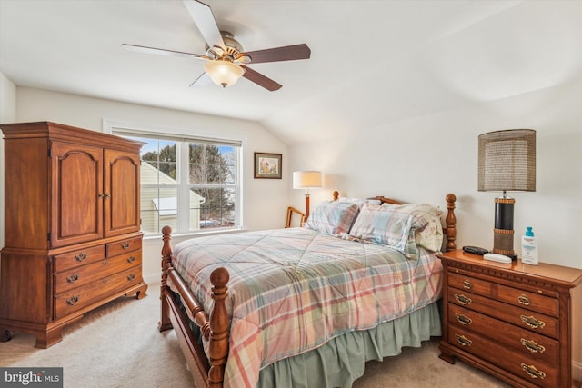 carpeted bedroom with vaulted ceiling and ceiling fan