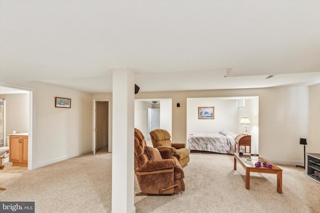 carpeted bedroom featuring ensuite bath