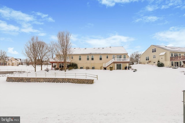 snow covered property with a deck