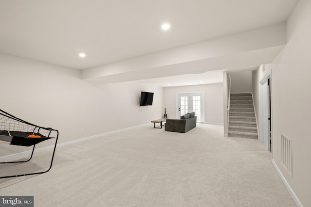 living area with french doors and light colored carpet