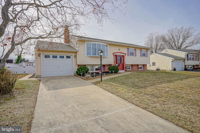 split foyer home with a garage and a front lawn