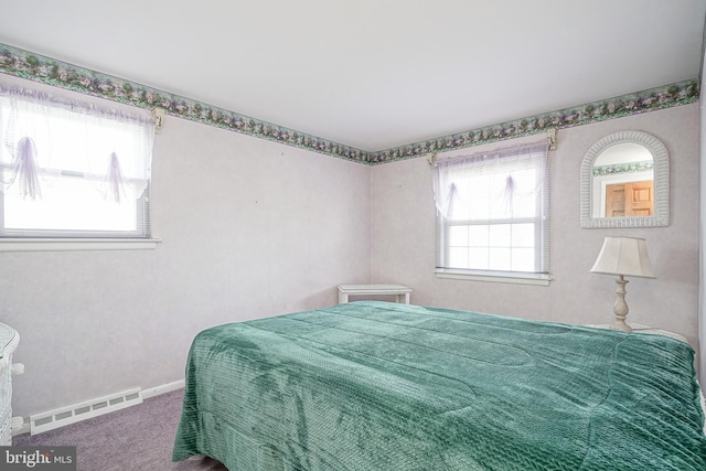 carpeted bedroom featuring a baseboard heating unit