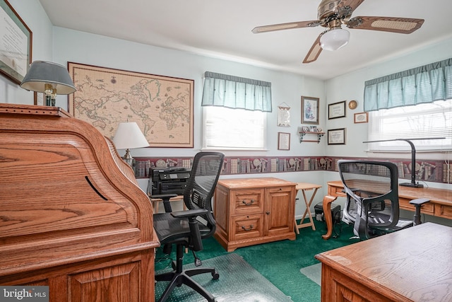 office space with ceiling fan and dark carpet