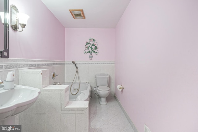 bathroom featuring a washtub, sink, tile patterned flooring, tile walls, and toilet