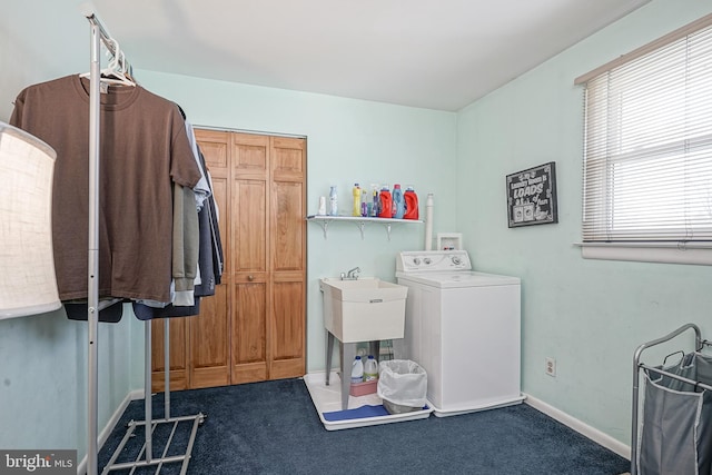 clothes washing area with washer / dryer and dark colored carpet