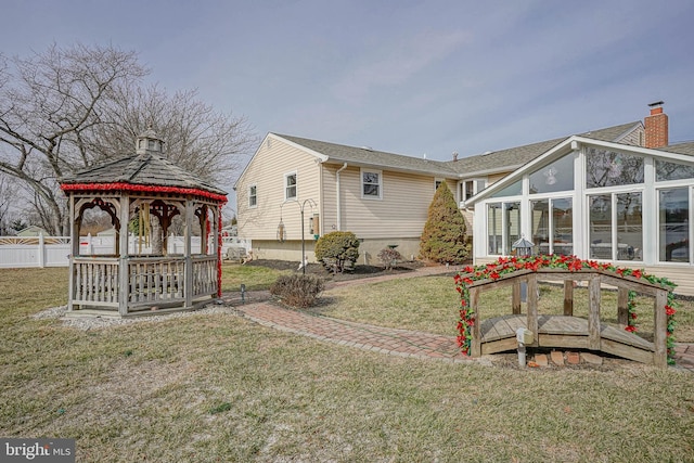 view of yard featuring a gazebo and a sunroom