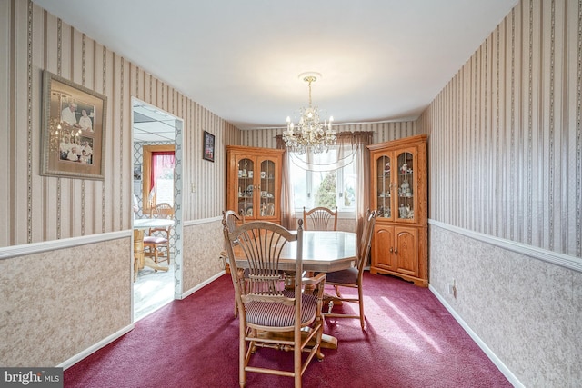 carpeted dining room featuring an inviting chandelier