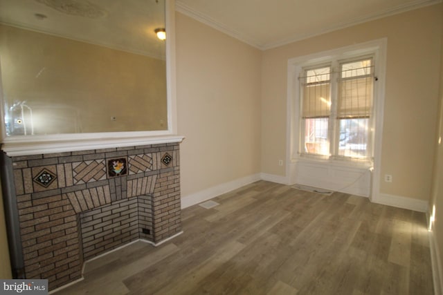 unfurnished living room with hardwood / wood-style flooring and ornamental molding