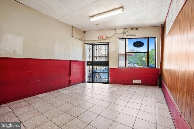 tiled empty room with wooden walls