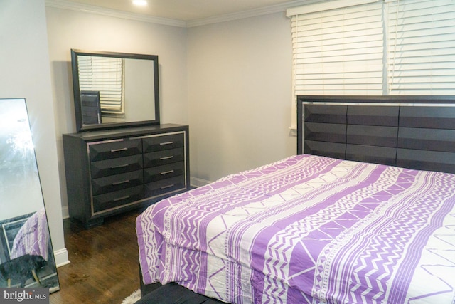 bedroom with crown molding and dark hardwood / wood-style floors