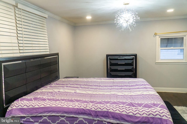 bedroom featuring ornamental molding, wood-type flooring, and a chandelier