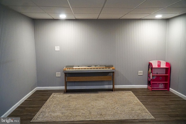 miscellaneous room featuring dark hardwood / wood-style floors and a drop ceiling