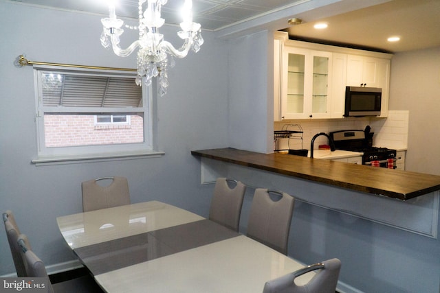 dining space featuring an inviting chandelier and radiator