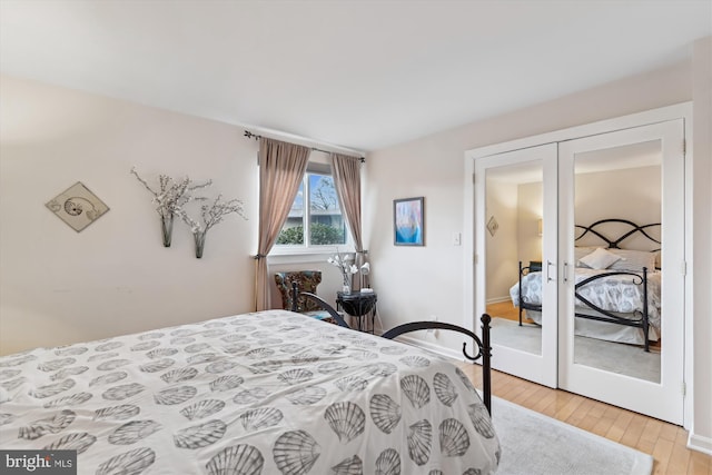 bedroom featuring light hardwood / wood-style flooring and french doors