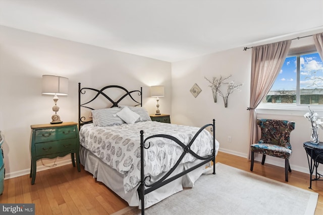 bedroom with hardwood / wood-style floors