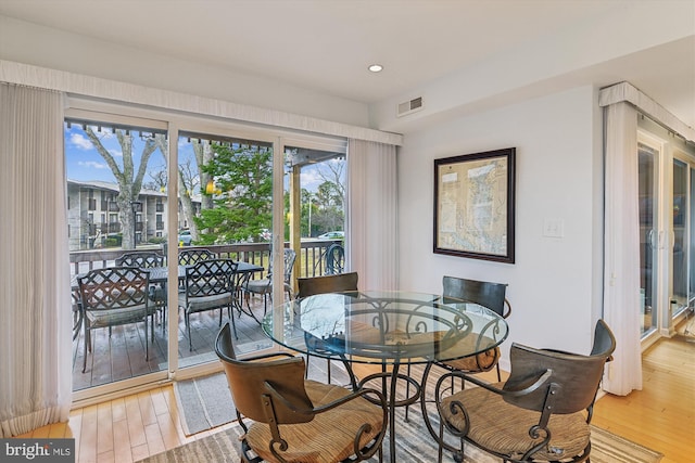 dining space with hardwood / wood-style flooring