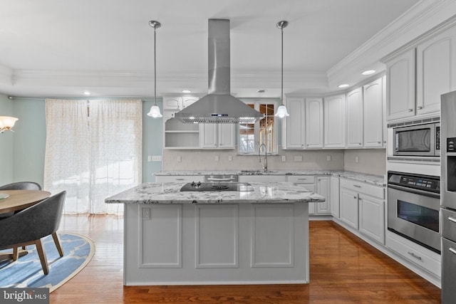 kitchen featuring pendant lighting, white cabinetry, stainless steel appliances, island exhaust hood, and a kitchen island