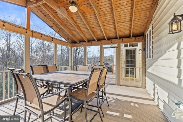 sunroom featuring lofted ceiling with beams and wooden ceiling