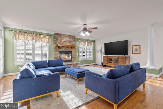 living room with decorative columns, ornamental molding, plenty of natural light, and hardwood / wood-style flooring