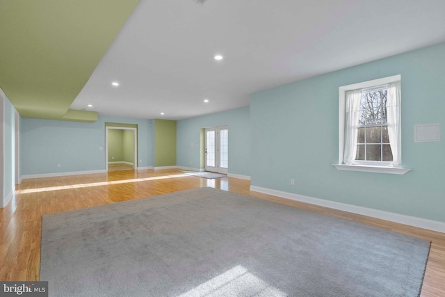 empty room with french doors and light hardwood / wood-style flooring