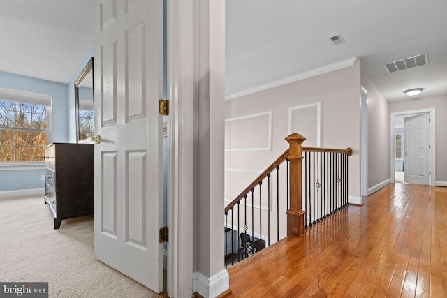 hallway with light hardwood / wood-style floors