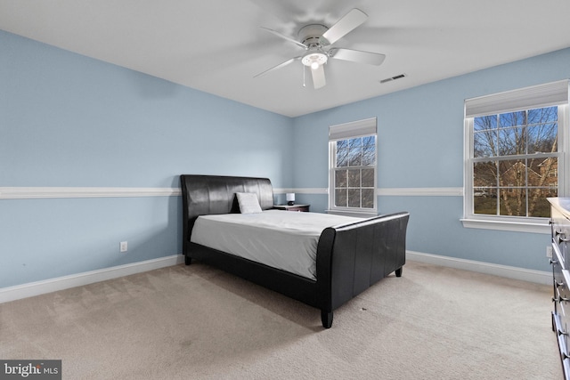 bedroom featuring light colored carpet and ceiling fan