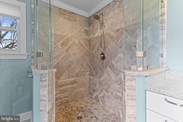 bathroom with ornamental molding and a shower with shower door