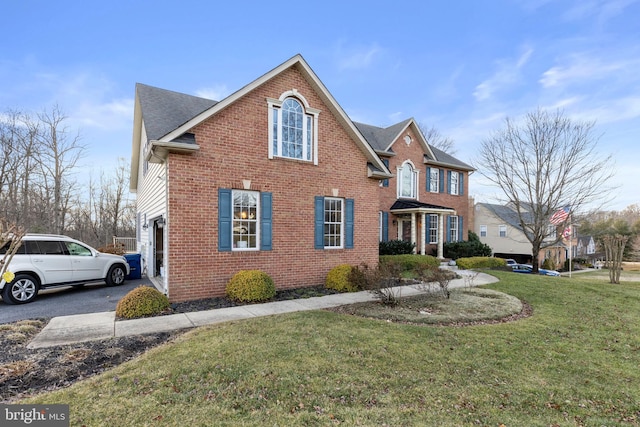 view of front property featuring a garage and a front yard