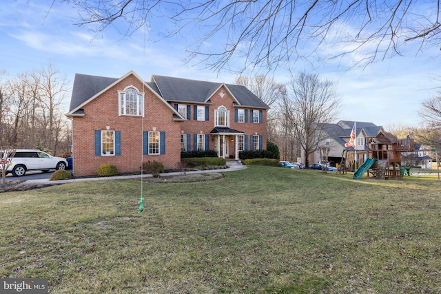 view of front of property featuring a playground and a front yard