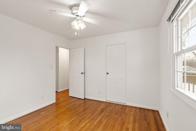 unfurnished bedroom with ceiling fan and hardwood / wood-style floors