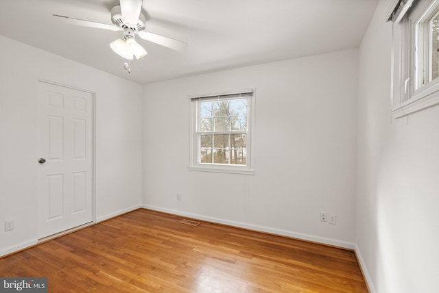 empty room with light hardwood / wood-style flooring and ceiling fan