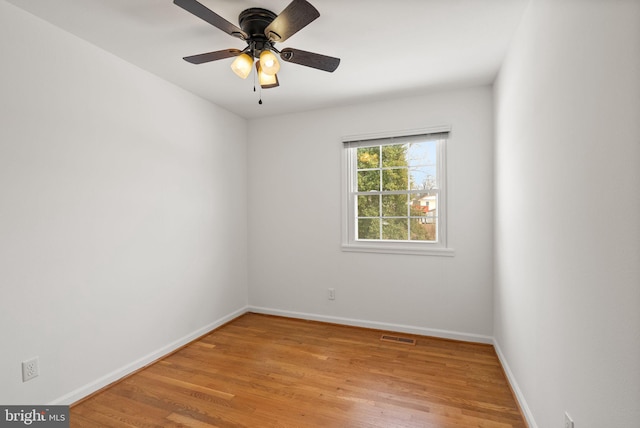 empty room with ceiling fan and light wood-type flooring