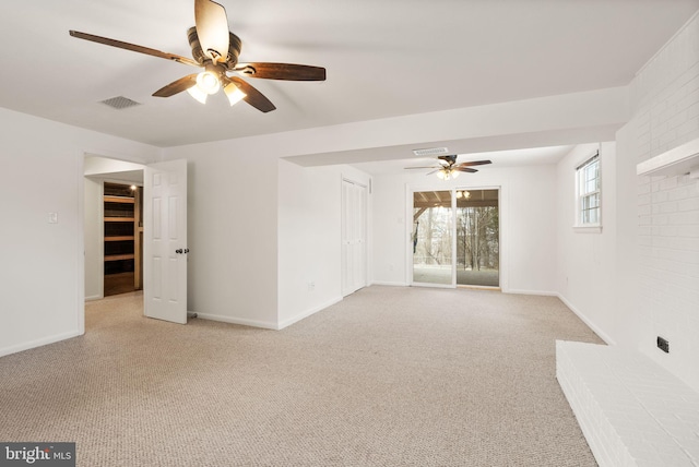 empty room featuring ceiling fan and light colored carpet