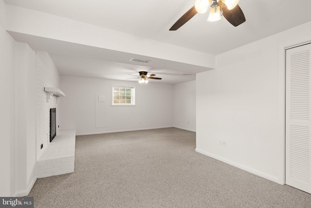 unfurnished living room featuring ceiling fan, light colored carpet, and a fireplace