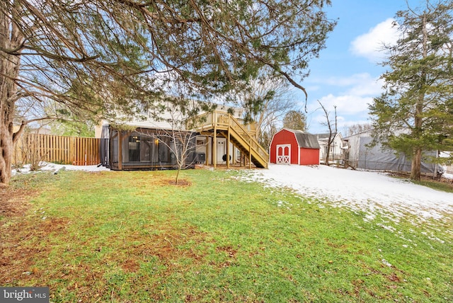 view of yard featuring a sunroom and a shed