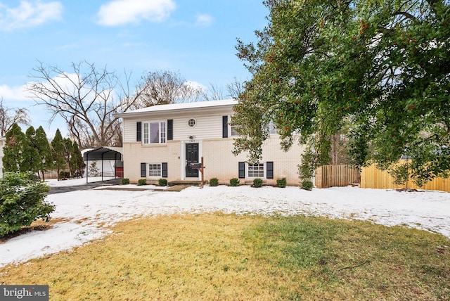 split foyer home with a front yard and a carport