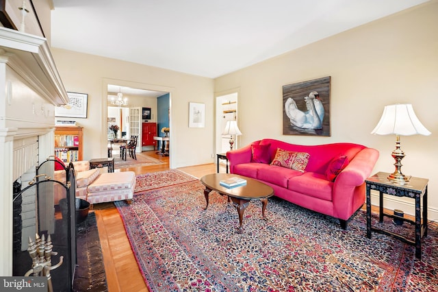 living room featuring a fireplace and a notable chandelier